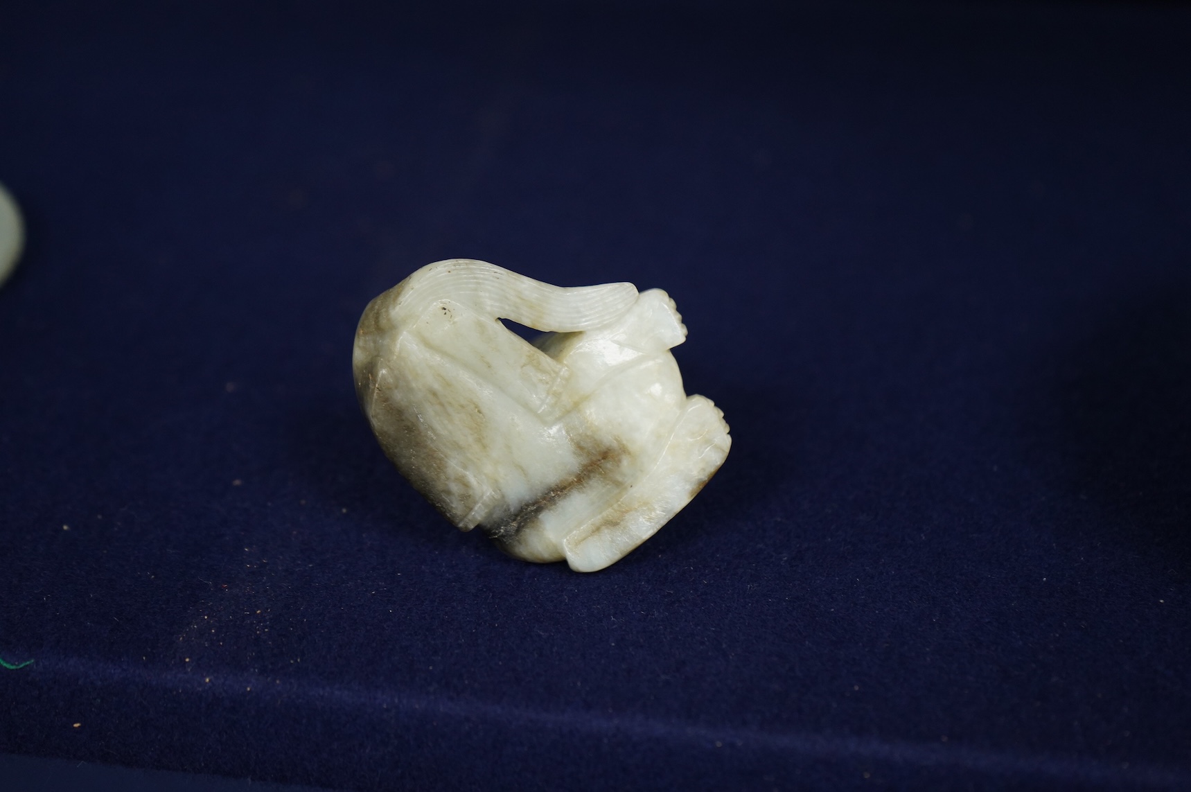 A Chinese white and black jade mythical beast, 5cm wide